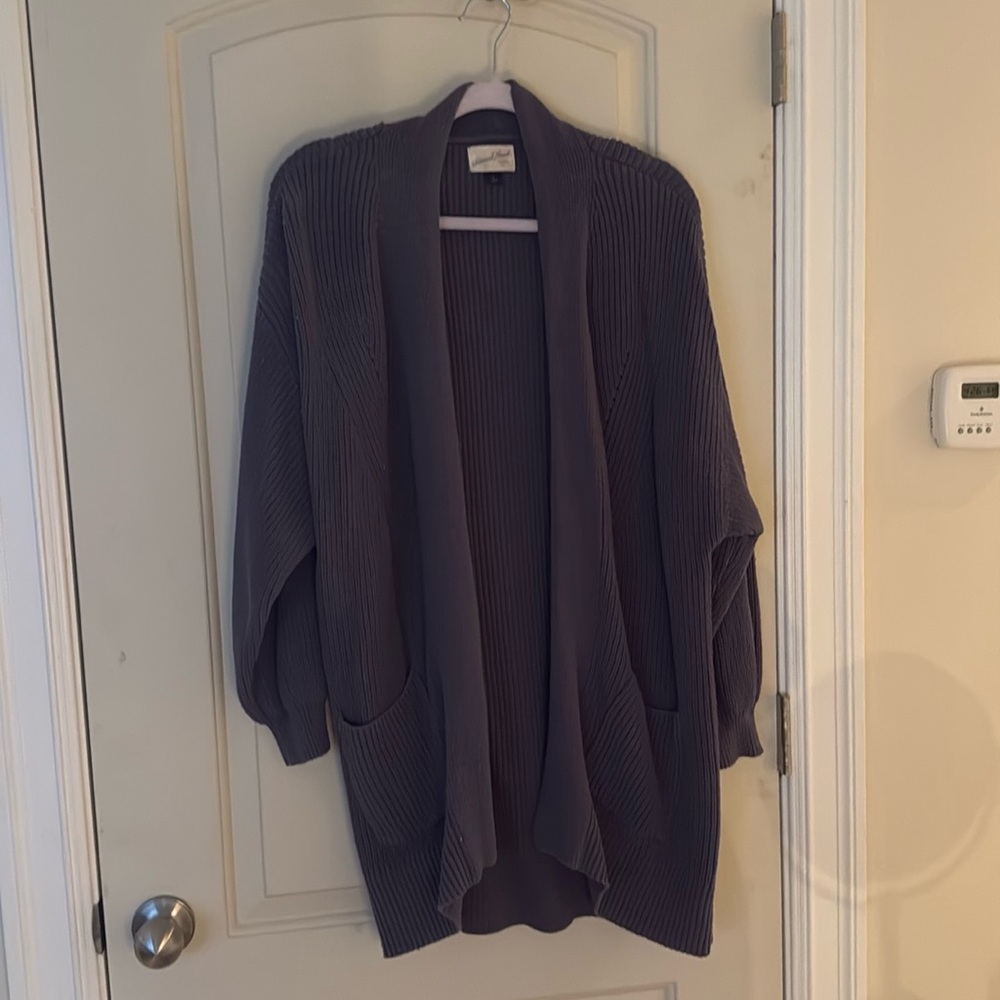 Lighter gray. Cardigan. Pockets in front.
